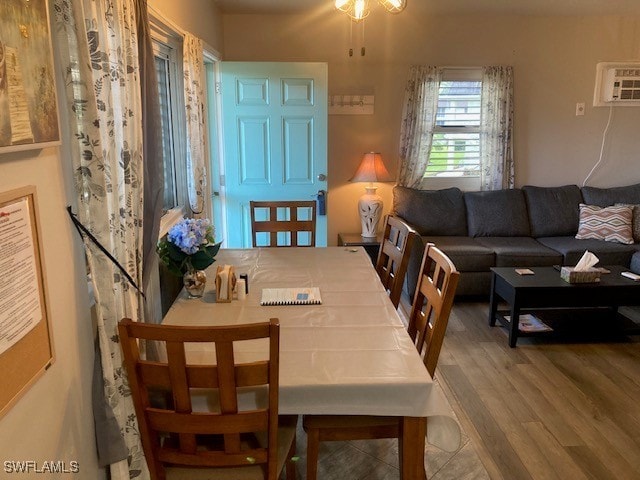130 N Collier Blvd Unit G6, Marco Island, FL 34145 - dining space with an AC wall unit, a ceiling fan, and wood finished floors