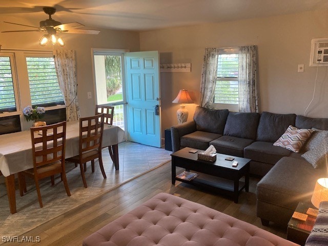 130 N Collier Blvd Unit G6, Marco Island, FL 34145 - living area with wood finished floors, a ceiling fan, and an AC wall unit