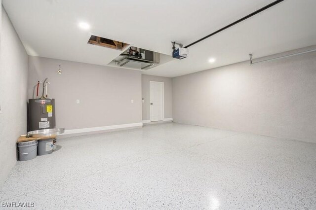 1603 Karen Ave S, Lehigh Acres, FL 33976 - garage featuring water heater, a garage door opener, and recessed lighting