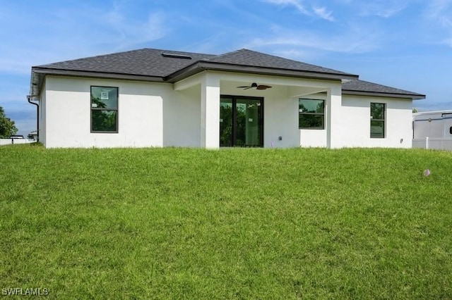 1603 Karen Ave S, Lehigh Acres, FL 33976 - rear view of house featuring a yard, ceiling fan, stucco siding, and a shingled roof