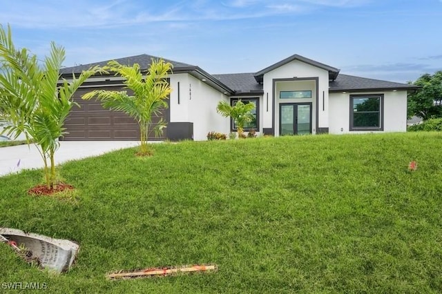 1603 Karen Ave S, Lehigh Acres, FL 33976 - view of front of home featuring concrete driveway, an attached garage, french doors, and stucco siding