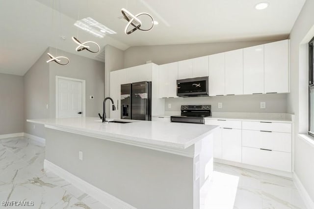 1603 Karen Ave S, Lehigh Acres, FL 33976 - kitchen with black range with electric cooktop, stainless steel microwave, refrigerator with ice dispenser, light marble finish flooring, and baseboards