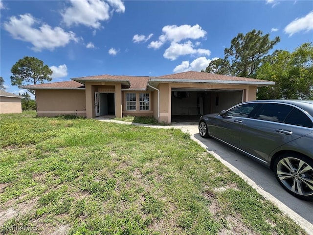3513 30th St SW, Lehigh Acres, FL 33976 - view of front of property with stucco siding, an attached garage, a front yard, and driveway