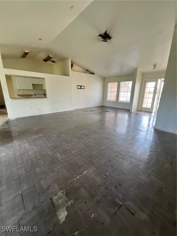 3513 30th St SW, Lehigh Acres, FL 33976 - unfurnished living room featuring lofted ceiling