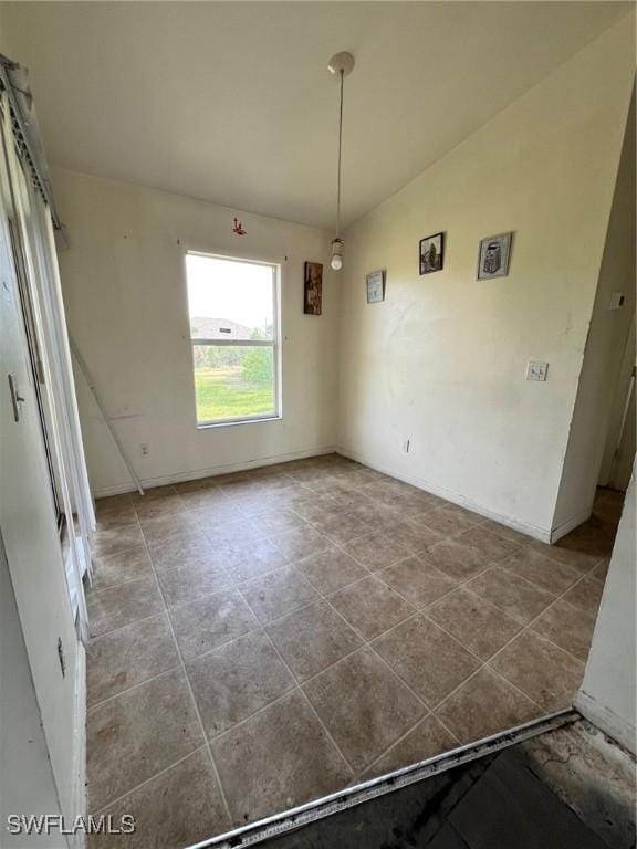 3513 30th St SW, Lehigh Acres, FL 33976 - unfurnished dining area featuring baseboards and tile patterned floors