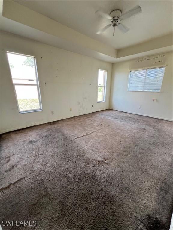 3513 30th St SW, Lehigh Acres, FL 33976 - carpeted spare room featuring a ceiling fan