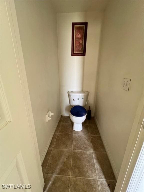 3513 30th St SW, Lehigh Acres, FL 33976 - bathroom featuring tile patterned floors, toilet, and baseboards