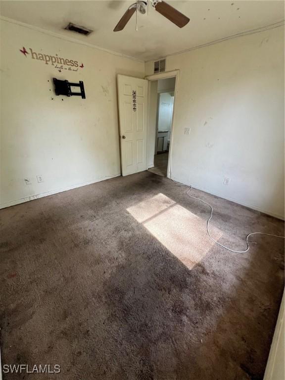 3513 30th St SW, Lehigh Acres, FL 33976 - spare room with ceiling fan, carpet, and crown molding