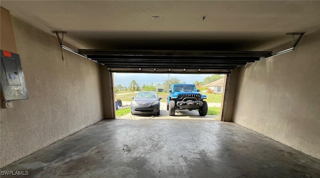 3513 30th St SW, Lehigh Acres, FL 33976 - garage featuring a textured wall and electric panel