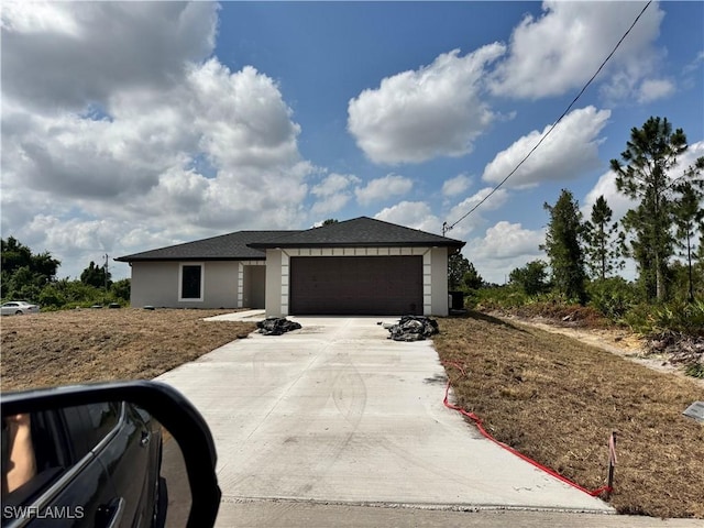 3007 53rd St W, Lehigh Acres, FL 33971 - view of front of property with an attached garage, stucco siding, and concrete driveway