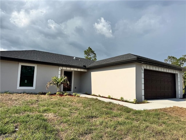 3007 53rd St W, Lehigh Acres, FL 33971 - view of front of property with a garage, concrete driveway, a front yard, stucco siding, and roof with shingles