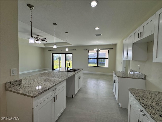 3007 53rd St W, Lehigh Acres, FL 33971 - kitchen featuring a sink, ceiling fan, plenty of natural light, light stone counters, and recessed lighting