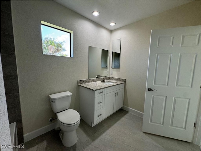 3007 53rd St W, Lehigh Acres, FL 33971 - bathroom with vanity, toilet, baseboards, recessed lighting, and a textured wall