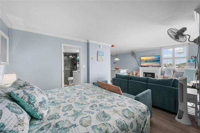 5500 Bonita Beach Rd Unit 502, Bonita Springs, FL 34134 - bedroom featuring crown molding, dark wood finished floors, a glass covered fireplace, and connected bathroom
