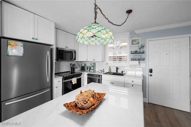 5500 Bonita Beach Rd Unit 502, Bonita Springs, FL 34134 - kitchen featuring stainless steel appliances, a sink, light countertops, white cabinetry, and ornamental molding