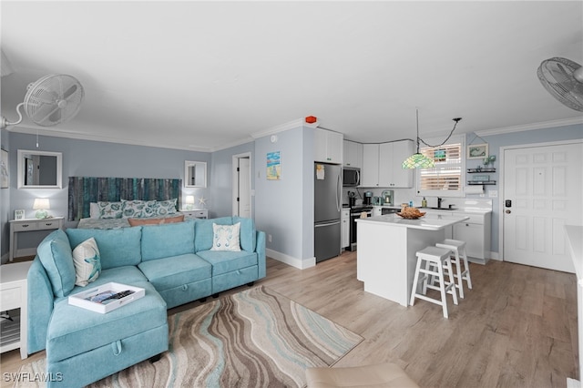 5500 Bonita Beach Rd Unit 502, Bonita Springs, FL 34134 - living room featuring ornamental molding, light wood finished floors, and baseboards