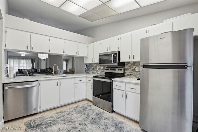 3410 Frosty Way Unit 4802, Naples, FL 34112 - kitchen with appliances with stainless steel finishes, a sink, light countertops, tasteful backsplash, and light tile patterned floors