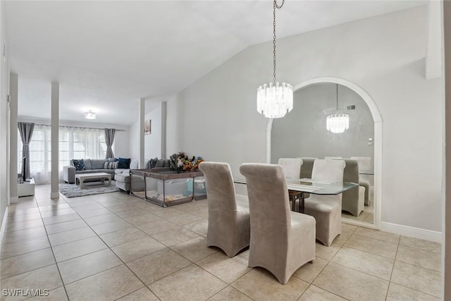 3410 Frosty Way Unit 4802, Naples, FL 34112 - dining area featuring light tile patterned floors, a chandelier, vaulted ceiling, and baseboards
