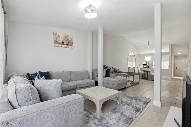 3410 Frosty Way Unit 4802, Naples, FL 34112 - living room featuring light tile patterned floors, lofted ceiling, and a chandelier