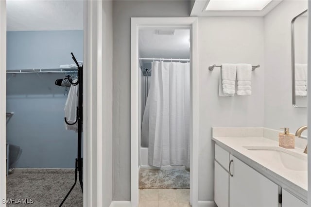 3410 Frosty Way Unit 4802, Naples, FL 34112 - bathroom with vanity, shower / bath combo with shower curtain, and a spacious closet