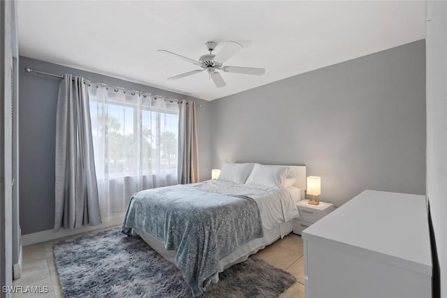 3410 Frosty Way Unit 4802, Naples, FL 34112 - bedroom with ceiling fan, light tile patterned flooring, and baseboards