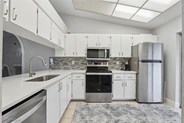 3410 Frosty Way Unit 4802, Naples, FL 34112 - kitchen with stainless steel appliances, a sink, tasteful backsplash, light tile patterned floors, and vaulted ceiling