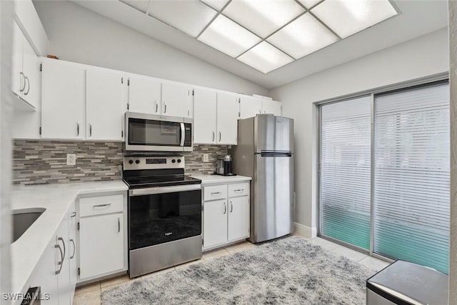 3410 Frosty Way Unit 4802, Naples, FL 34112 - kitchen with appliances with stainless steel finishes, decorative backsplash, light countertops, white cabinets, and lofted ceiling