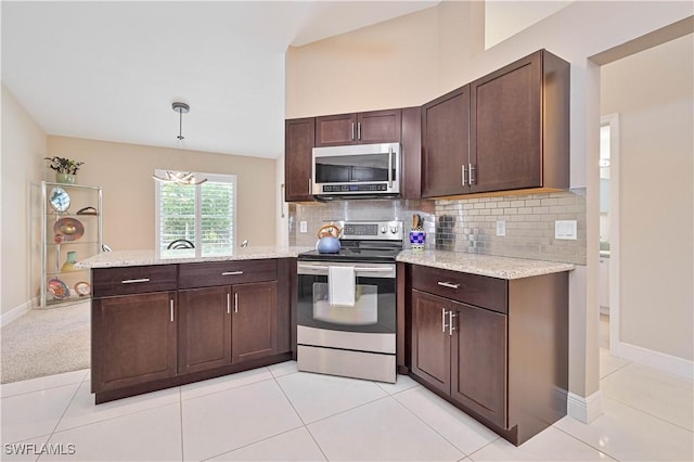 15041 Bridgeway Ln Unit 1006, Fort Myers, FL 33919 - kitchen featuring stainless steel appliances, a peninsula, decorative backsplash, and dark brown cabinets