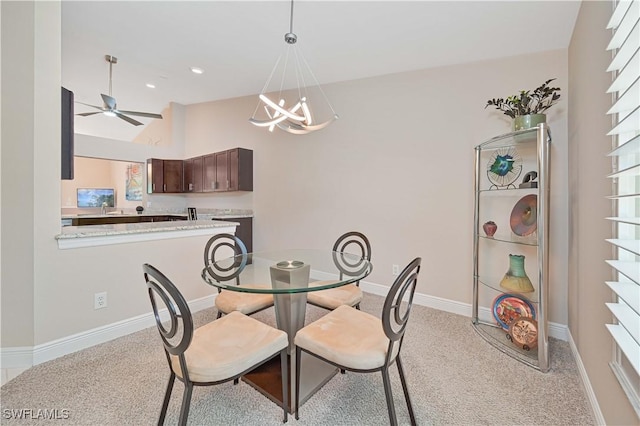 15041 Bridgeway Ln Unit 1006, Fort Myers, FL 33919 - dining room with ceiling fan, light carpet, baseboards, a chandelier, and lofted ceiling
