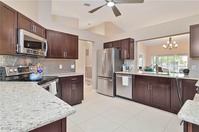 15041 Bridgeway Ln Unit 1006, Fort Myers, FL 33919 - kitchen featuring stainless steel appliances, decorative backsplash, a chandelier, a sink, and dark brown cabinets
