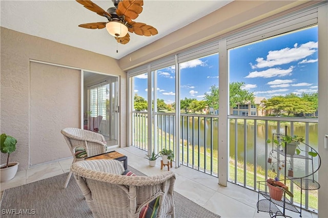 15041 Bridgeway Ln Unit 1006, Fort Myers, FL 33919 - sunroom featuring a water view, ceiling fan, a textured wall, and tile patterned floors