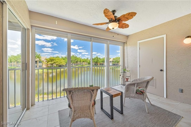 15041 Bridgeway Ln Unit 1006, Fort Myers, FL 33919 - sunroom with a textured wall, a water view, a ceiling fan, and a textured ceiling