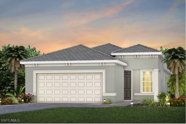 17321 Willow Tree Ln, North Fort Myers, FL 33917 - view of front of property featuring a garage, driveway, and stucco siding