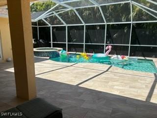 672 Seagrape Dr, Marco Island, FL 34145 - view of swimming pool with a patio, a pool with connected hot tub, and glass enclosure