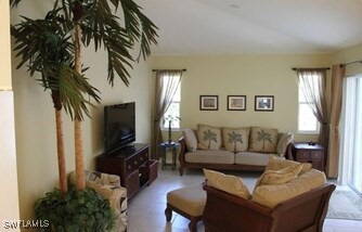 672 Seagrape Dr, Marco Island, FL 34145 - living area with healthy amount of natural light and lofted ceiling