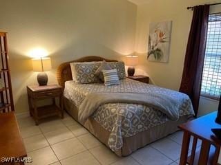 672 Seagrape Dr, Marco Island, FL 34145 - bedroom with light tile patterned floors