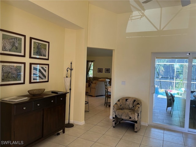 672 Seagrape Dr, Marco Island, FL 34145 - hall featuring light tile patterned floors, baseboards, and a high ceiling