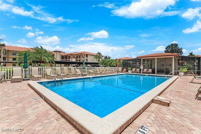 7340 Coventry Ct Unit 827, Naples, FL 34104 - community pool featuring a sunroom and a patio area