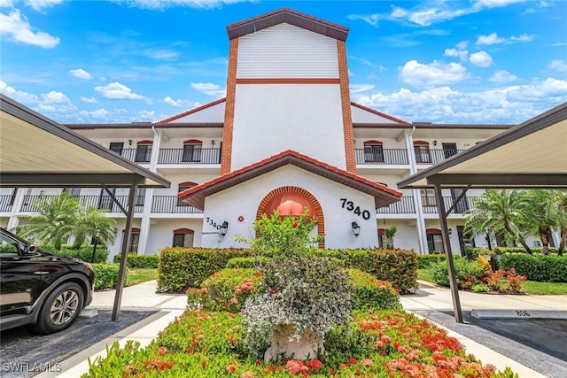 7340 Coventry Ct Unit 827, Naples, FL 34104 - view of property featuring covered parking
