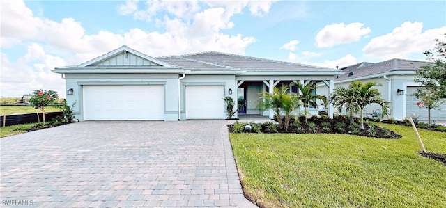 7393 Blue Salvia Dr, North Fort Myers, FL 33917 - ranch-style house with decorative driveway, a garage, a front yard, stucco siding, and a tiled roof