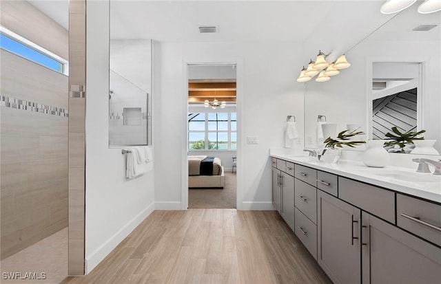 7393 Blue Salvia Dr, North Fort Myers, FL 33917 - ensuite bathroom with double vanity, wood finished floors, walk in shower, and baseboards