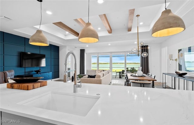 7393 Blue Salvia Dr, North Fort Myers, FL 33917 - kitchen featuring recessed lighting, light countertops, open floor plan, hanging light fixtures, and a sink