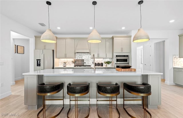 7393 Blue Salvia Dr, North Fort Myers, FL 33917 - kitchen featuring high end fridge, decorative backsplash, light countertops, gray cabinetry, and recessed lighting