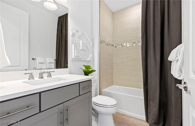 7393 Blue Salvia Dr, North Fort Myers, FL 33917 - full bath featuring vanity, toilet, shower / bathtub combination with curtain, and wood finished floors