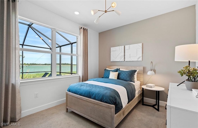 7393 Blue Salvia Dr, North Fort Myers, FL 33917 - bedroom featuring carpet flooring, baseboards, a chandelier, and a water view