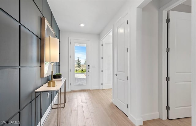 7393 Blue Salvia Dr, North Fort Myers, FL 33917 - doorway to outside with baseboards, light wood-style flooring, and recessed lighting