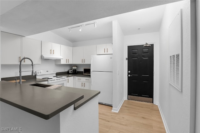 8224 Key Royal Cir Unit 232, Naples, FL 34119 - kitchen with white appliances, under cabinet range hood, dark countertops, rail lighting, and a peninsula