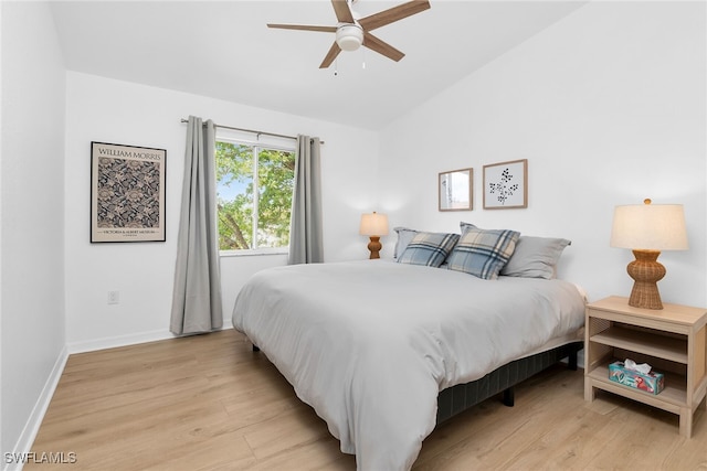 8224 Key Royal Cir Unit 232, Naples, FL 34119 - bedroom featuring light wood-style floors, lofted ceiling, baseboards, and ceiling fan