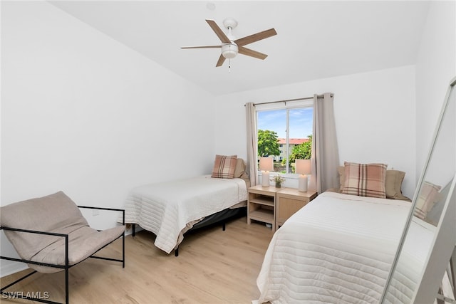 8224 Key Royal Cir Unit 232, Naples, FL 34119 - bedroom with vaulted ceiling, light wood-style flooring, and a ceiling fan