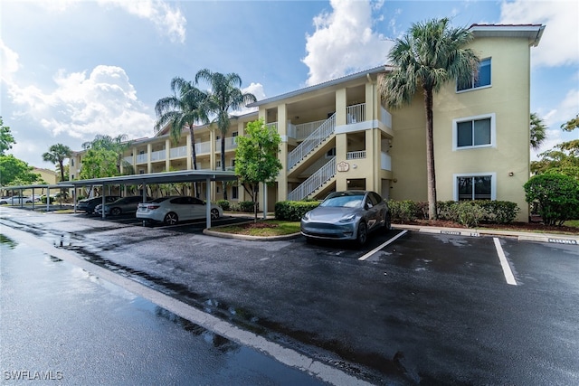 8224 Key Royal Cir Unit 232, Naples, FL 34119 - view of apartment building / complex featuring covered and uncovered parking and stairway